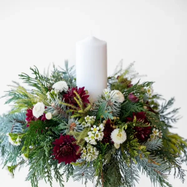 christmas centrepiece with red and white flowers and green foliage