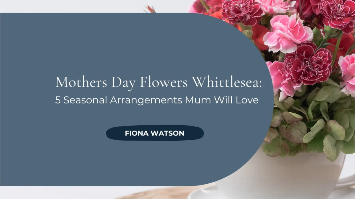 A vibrant Mother's Day flower arrangement featuring pink carnations, red roses and mixed seasonal blooms in a white ceramic teacup vase on a wooden table, with the text 'Mothers Day Flowers Whittlesea: 5 Seasonal Arrangements Mum Will Love' by Fiona Watson.
