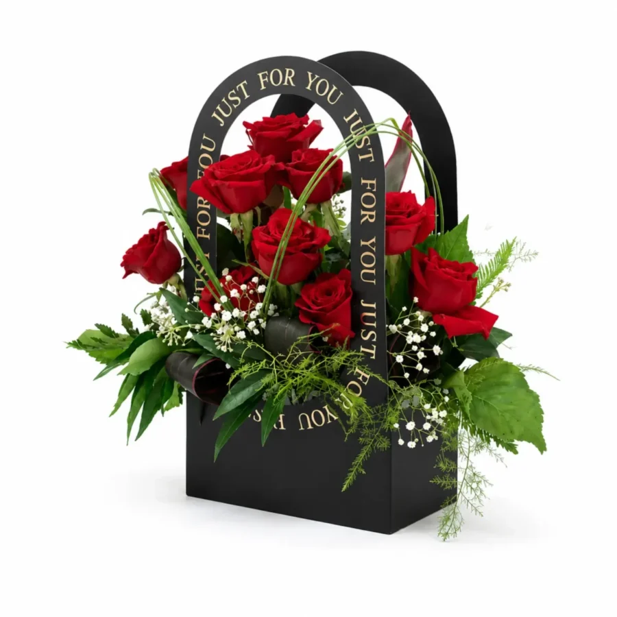 Luxury red rose arrangement in a black gift box with fresh greenery and white filler flowers.