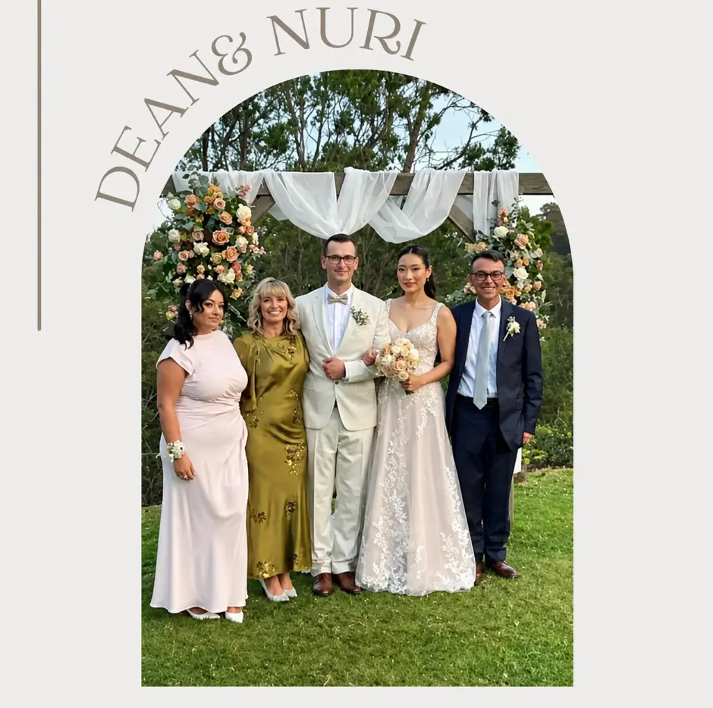 Garden Wedding Ceremony Flowers Melbourne Couple celebrating beneath a garden wedding ceremony arbour with seasonal flowers